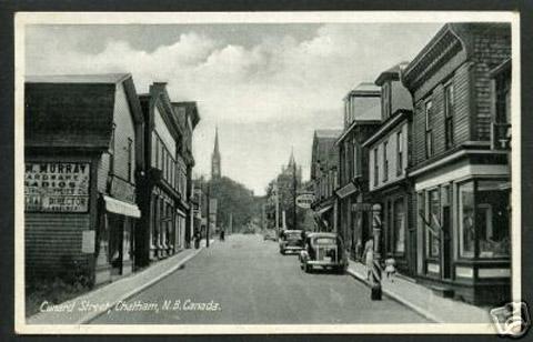 Cunard Street, Ken Breau's barber shop on right, barber post in front, circa 1940's.; City of Miramichi