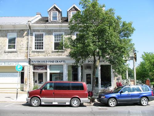 View of main (south) facade showing ground floor storefronts and attic level dormers – August 2004; Sawchuck, 2004
