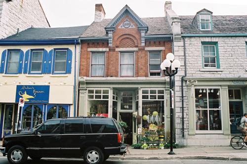 View of façade at 68 Princess Street showing brick cladding and pediment added in 1893 – July 2004; OHT, 2004