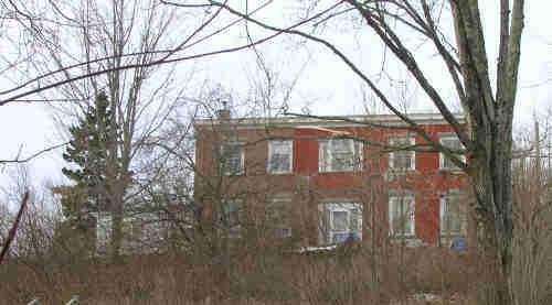 The front facade of the house; Norma Stewart