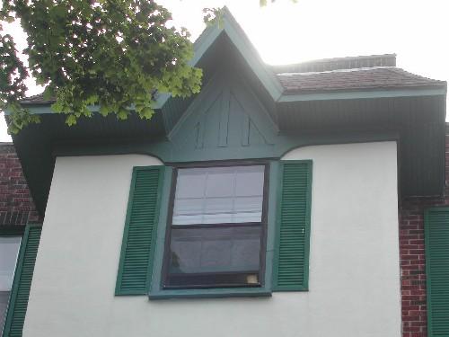 This image provides a view of the hipped roof with gable detail crowning the central bay, 2005.; City of Saint John