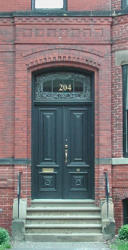 This image the segmented arch entrance over the wooden doors, 2005.; City of Saint John