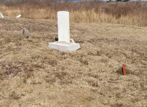 A grave marker in its new base at Founders Cemetery, Beaver River, Yarmouth County, NS, 2008. These new bases are individually made to suit each marker.; Heritage Division, NS Dept. of Tourism, Culture & Heritage, 2008.