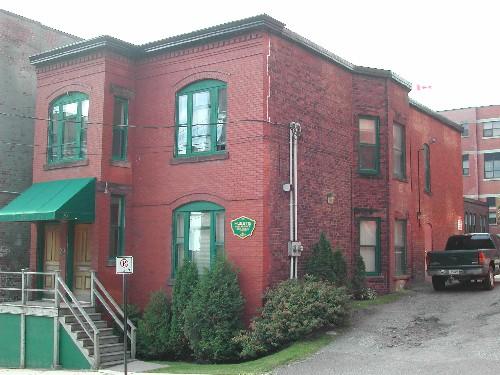 This photograph shows the front façade and the eastern side facade, 2005.; City of Saint John