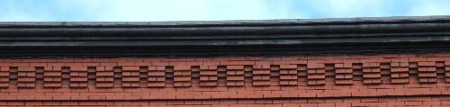 This image provides a view of the cornice ornamented by brick corbel bands, 2005.; City of Saint John