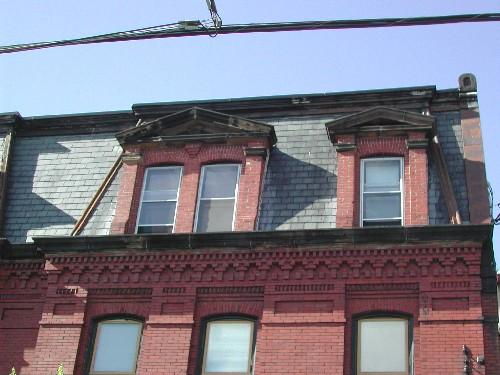 This photograph shows the pedimented dormers and the elaborate brick detail at the cornice, 2005
; City of Saint John