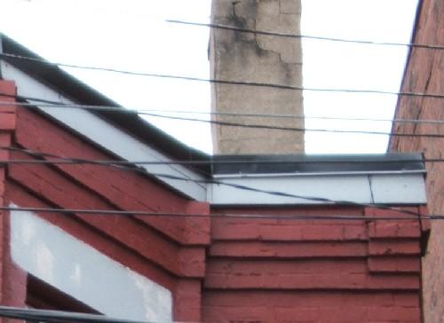 This image provides a view of the stone and brick cornice with a brick corbel band, 2005.; City of Saint John