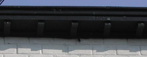 This image provides a view of the cornice supported by exposed rafters, 2005.; City of Saint John