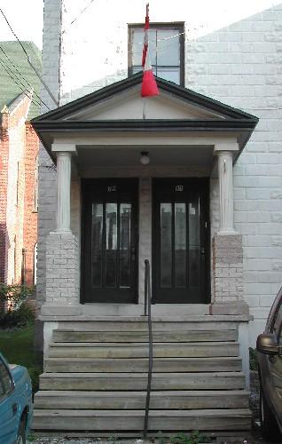 This image provides a view of the pedimented portico supported by Doric columns, 2005.  

; City of Saint John