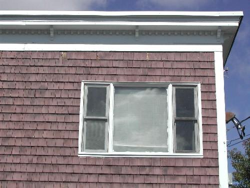 This photograph shows the large cornice, decorated with dentils and brackets, 2005.; City of Saint John