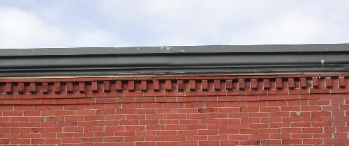 This image provides a view cornice ornamented by brick dentils, 2005.; City of Saint John