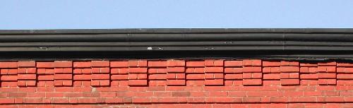 This image provides a view of the cornice ornamented by brick corbel bands, 2005.; City of Saint John