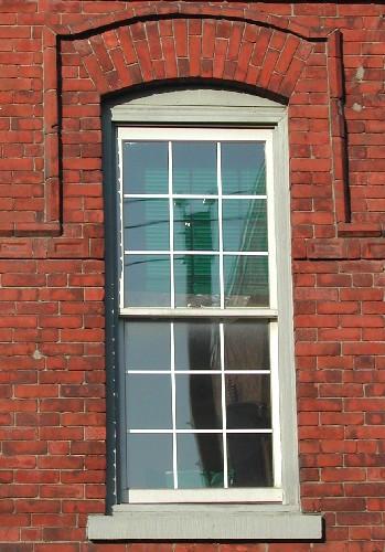 This image provides a view of a segmented arched window, 2005.
; City of Saint John