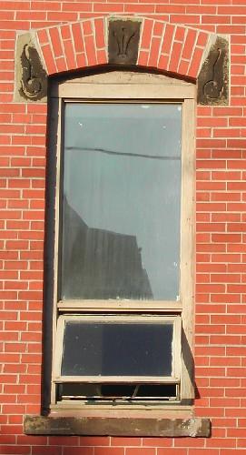 This image provides a view of a segmented arched window opening, 2005.; City of Saint John