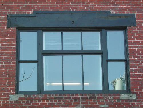 This image provides a view of the large, central, second storey window with a wood lintel and brick sill, 2005.; City of Saint John