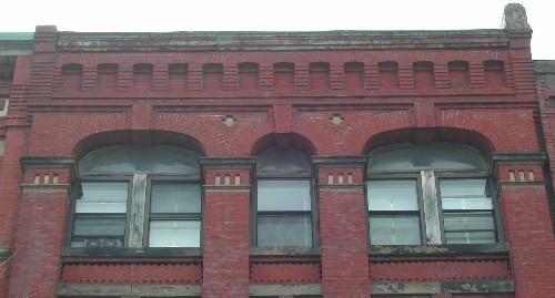 This photograph shows the cornice with corbel bands and the large pilasters, 2005.; City of Saint John