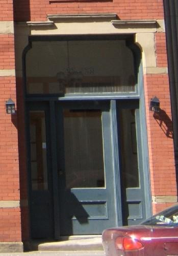 This photograph shows the entrance with its large transom window, 2005; City of Saint John