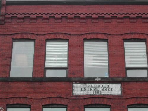 This photograph shows the cornice and upper storey windows on the Prince William Street façade. Also visible is the Dearborn sign, 2005; City of Saint John