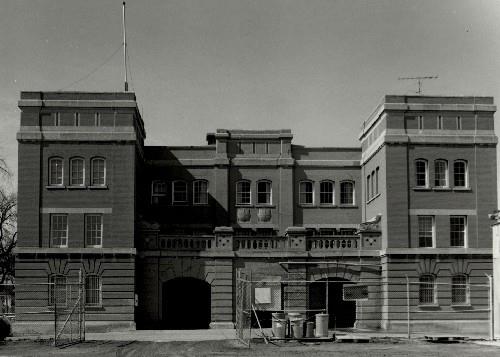 Rear view of the McGregor Street Armoury, showing the symmetrical relationship of the multi-paned sash windows and doors with transoms, 1994.; Department of National Defence / Ministère de la Défense nationale, 1994.