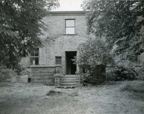 Main façade prior to restoration, showing visible shadow of original verandah covering – c. 1968; OHT, c. 1968