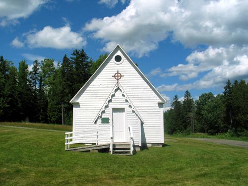 This image shows the front façade of the chapel adorned with Gothic arch and shamrock trim, 2007.; Province of New Brunswick