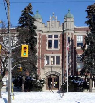A pair of brick and stone turrets on the west facade of Elizabeth Ziegler Public School, 2007.; Kayla Jonas, 2007