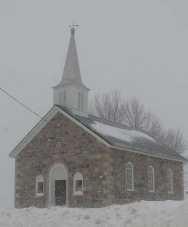 North and west elevations of the Church depicting the arched wooden doors and 6/6 windows, 2007.; Kayla Jonas, 2007.
