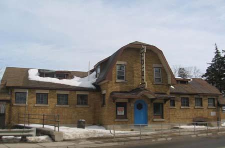 The facade of the Beatty Pool, featuring a unique arched entrance door and gambrel roof.; Lindsay Benjamin, 2007.