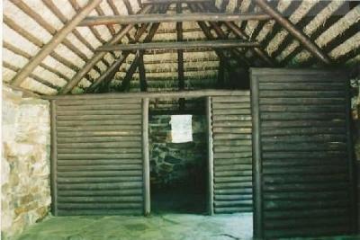Interior view of the Lone Shieling, showing the simple interior rectangular plan divided into two sections by log partitions, 1993.; Parks Canada Agency / Agence Parcs Canada, 1993.