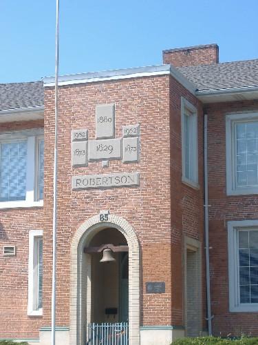 Date and name stones on the tower of Robertson Public School above the bell.; Photograph by Callie Hemsworth, 2007.