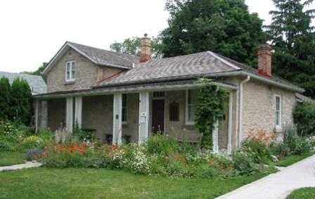 Facade of the John McCrae House which displays the simple architecture and the large front porch.; Frank Hochstenbach, 2004.