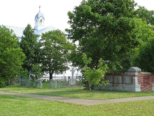 View of the wall of the former hospital, the Religious Hospitallers of St. Joseph Cemetry and the bell tower of the Ste-Famille Academy.; Town of Tracadie-Sheila