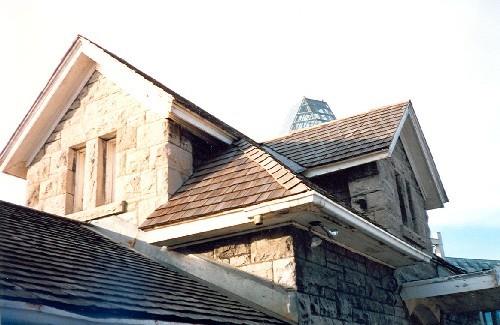Detail view of the Maintenance Building, showing the hip and cross gable roof, 1988.; Parks Canada Agency / Agence Parcs Canada, 1988.