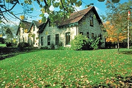 Corner view of the House, showing the brick-veneer exterior walls and trim treatment, 1984.; Parks Canada Agency / Agence Parcs Canada, 1984.